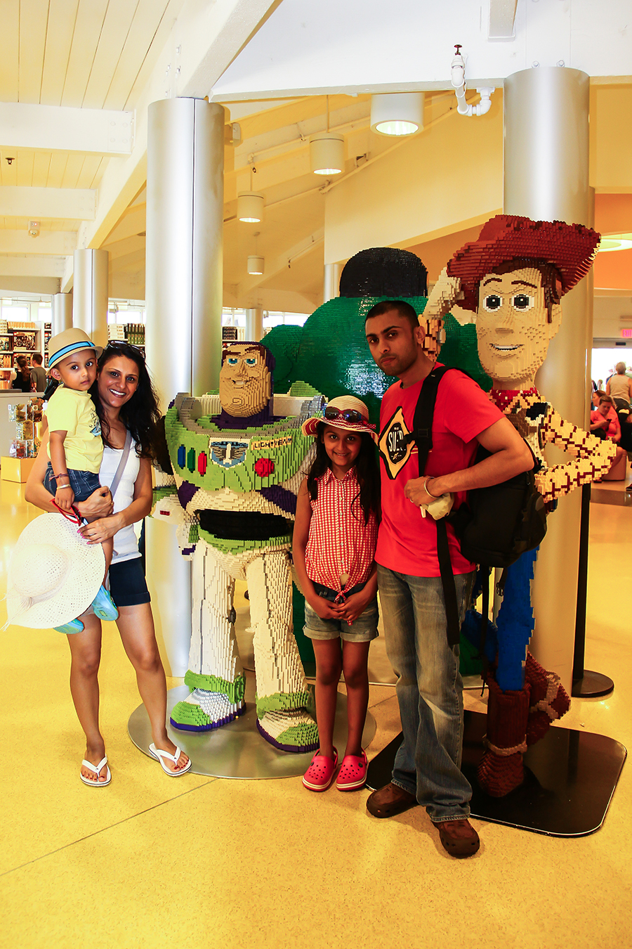 The four of us pose with Lego sculptures of Buzz and Woody in Orlando, Florida