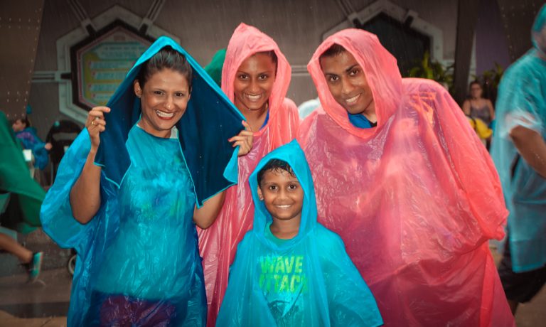 Sukh, the kids and I in our ponchos at Magic Kingdom in the Orlando downpour