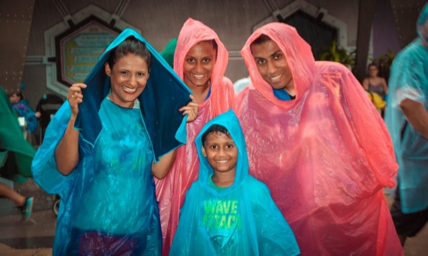 Sukh, the kids and I in our ponchos at Magic Kingdom in the Orlando downpour