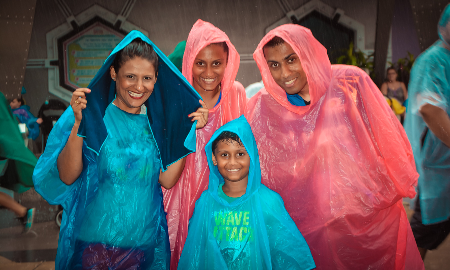 Sukh, the kids and I in our ponchos at Magic Kingdom in the Orlando downpour