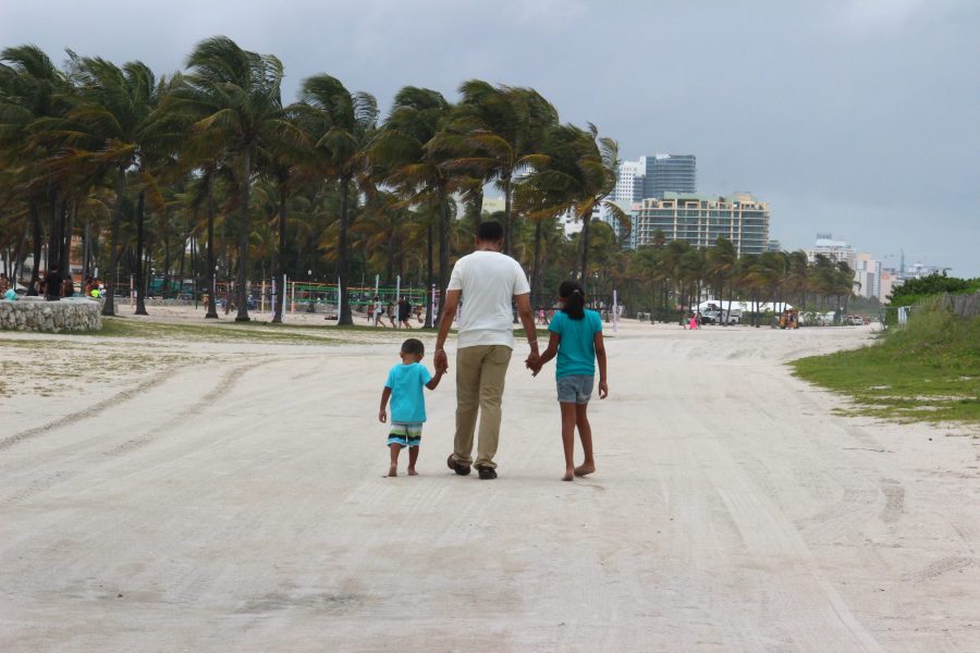 Father and children walking on the beach