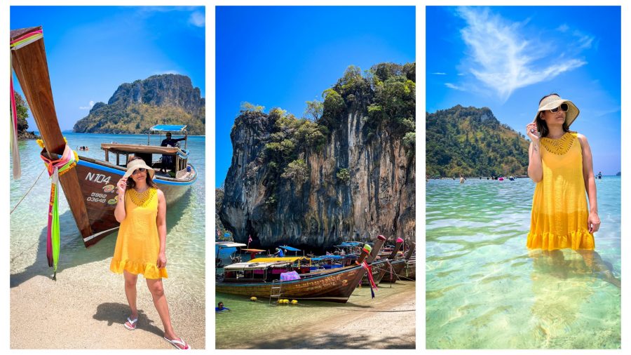 A traveller standing in crystal-clear turquoise waters, with a backdrop of a tropical island