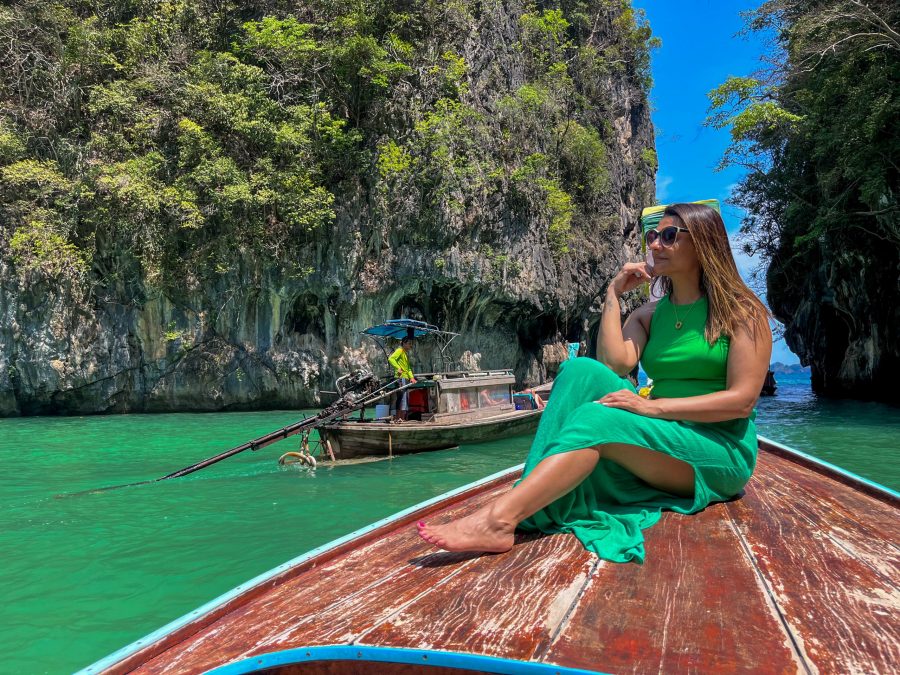 Enjoying a serene ride on a long-tail boat through the tranquil waters of Hong Lagoon, Thailand, as part of our 2-week Thailand itinerary.