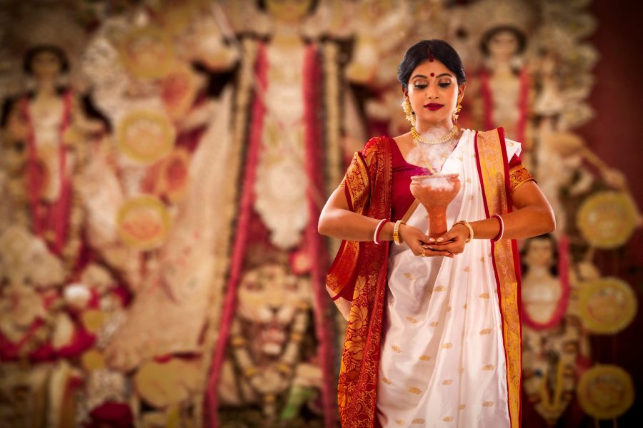 A woman doing Durga Puja, one of the best festivals in India
