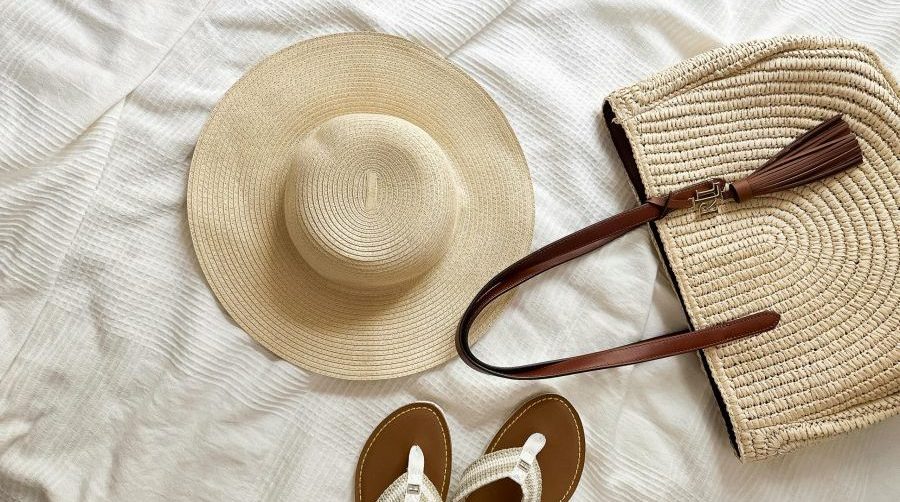 Sunhat, beach bag and flip flops on a towel - Goa Packing list essentials