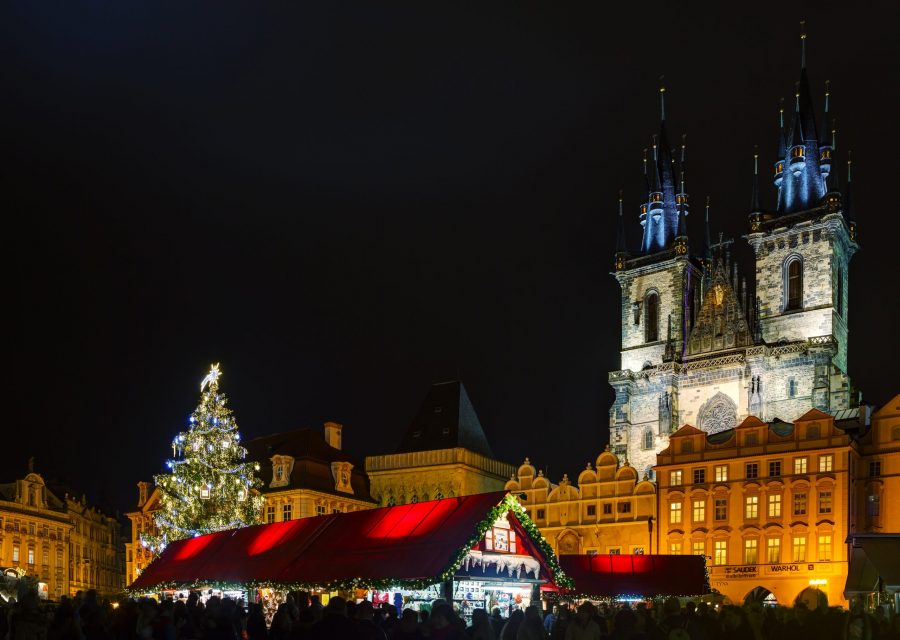 Prague with giant Christmas tree and market stalls.