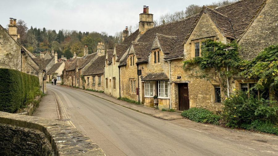 Traditional Cotswolds village with stone cottages and narrow streets.