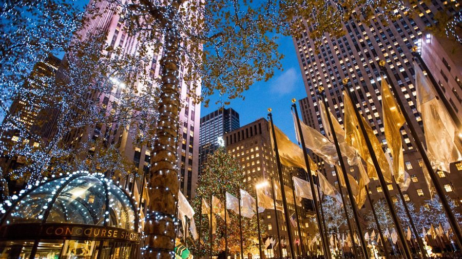 Rockefeller Center Christmas Tree in New York at Christmas, with ice skaters in the foreground.