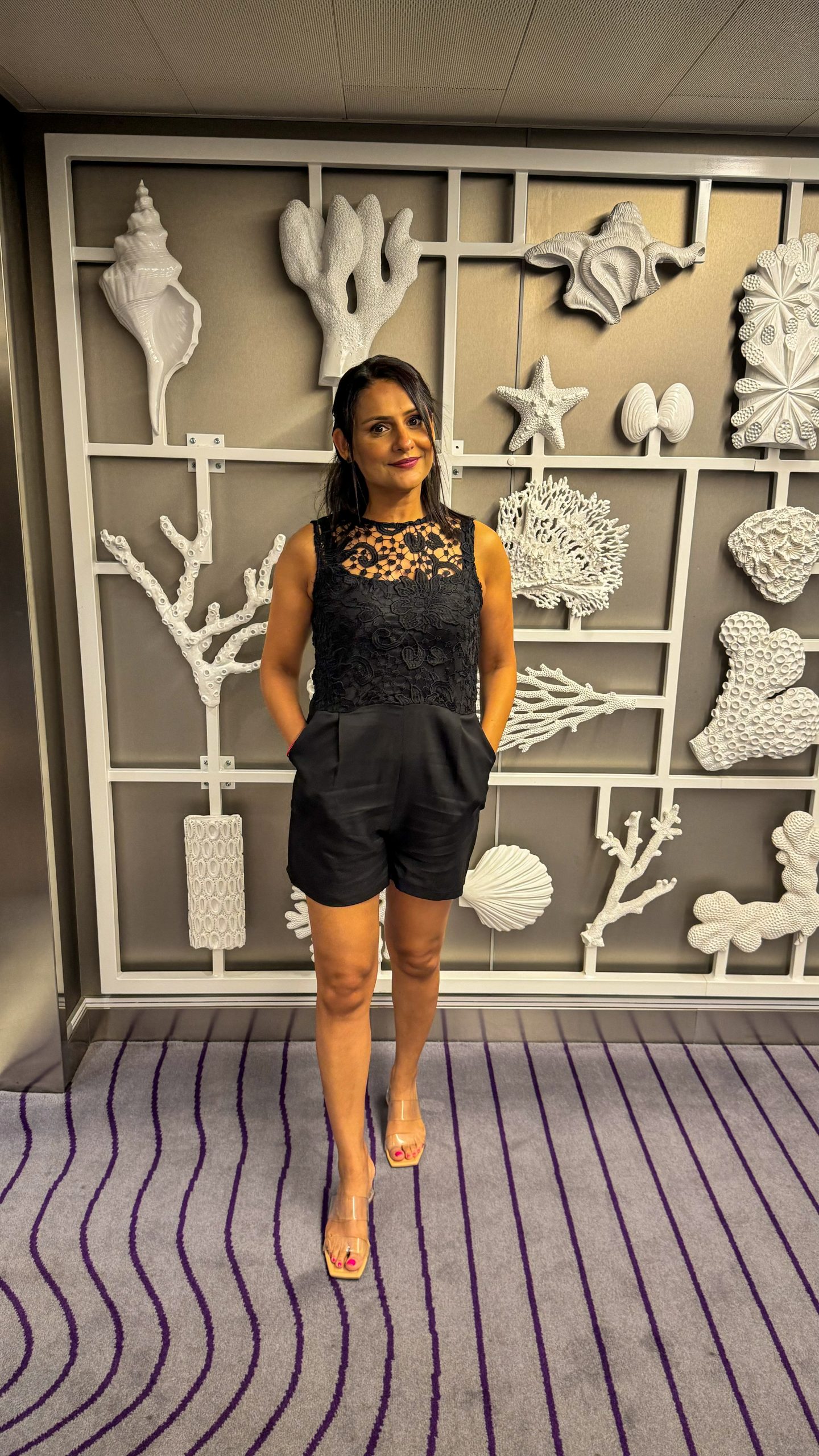 Woman in a black outfit walking to dinner onboard Virgin Voyages Scarlet Lady