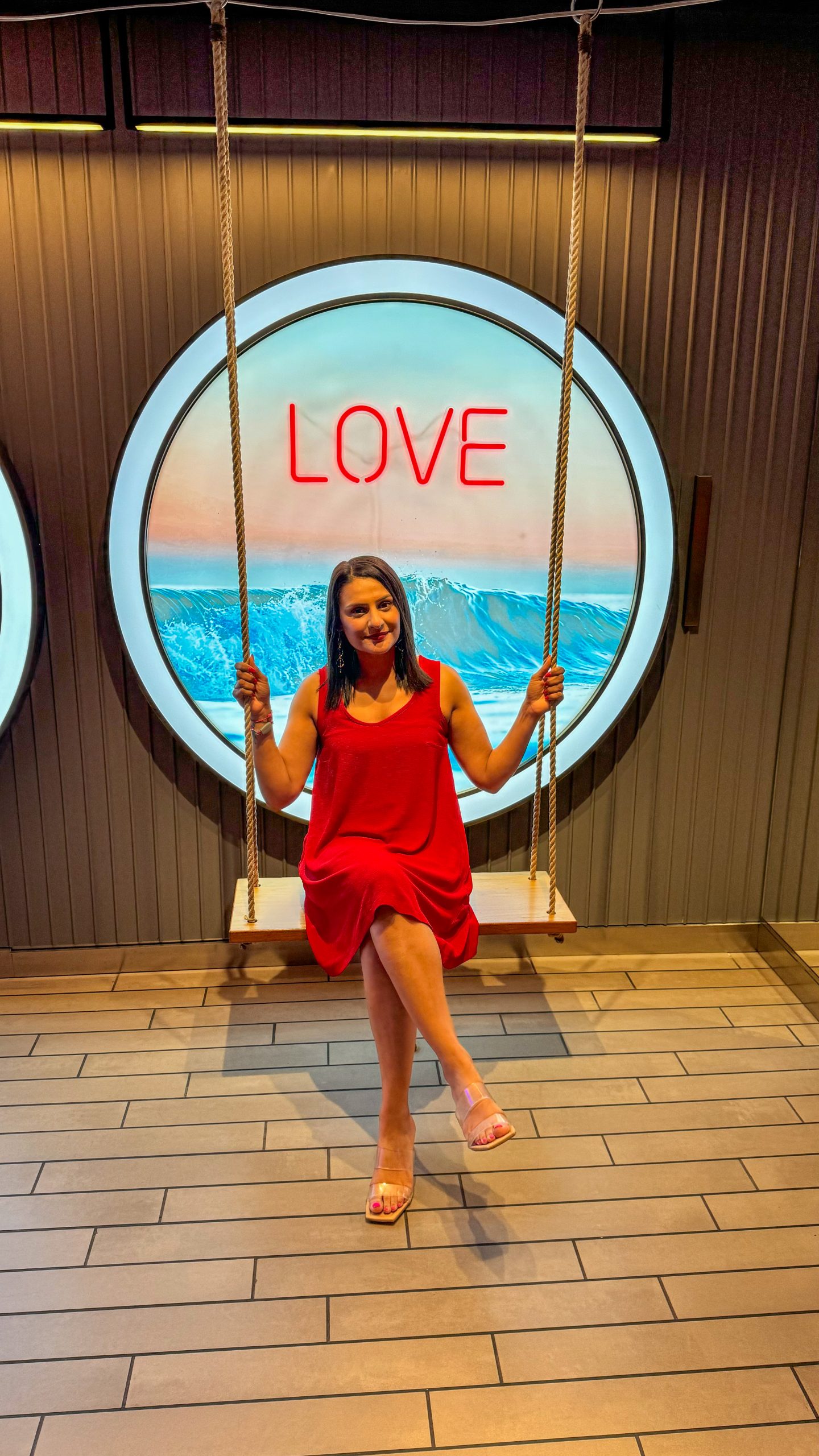 Rosie in a red dress ready for Scarlet Night party on Virgin Voyages