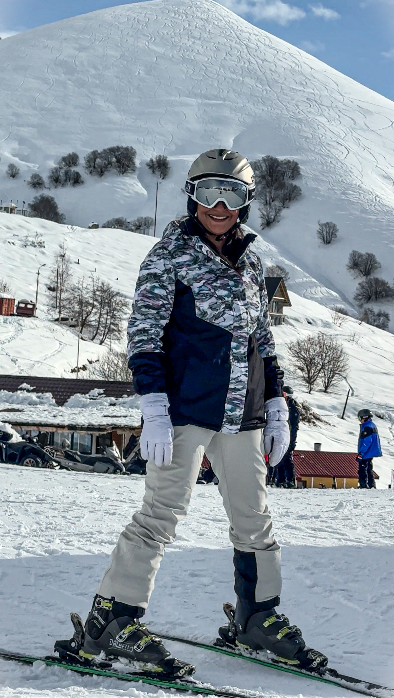 Woman smiling in ski gear and on skis for the first time skiing in Gudauri