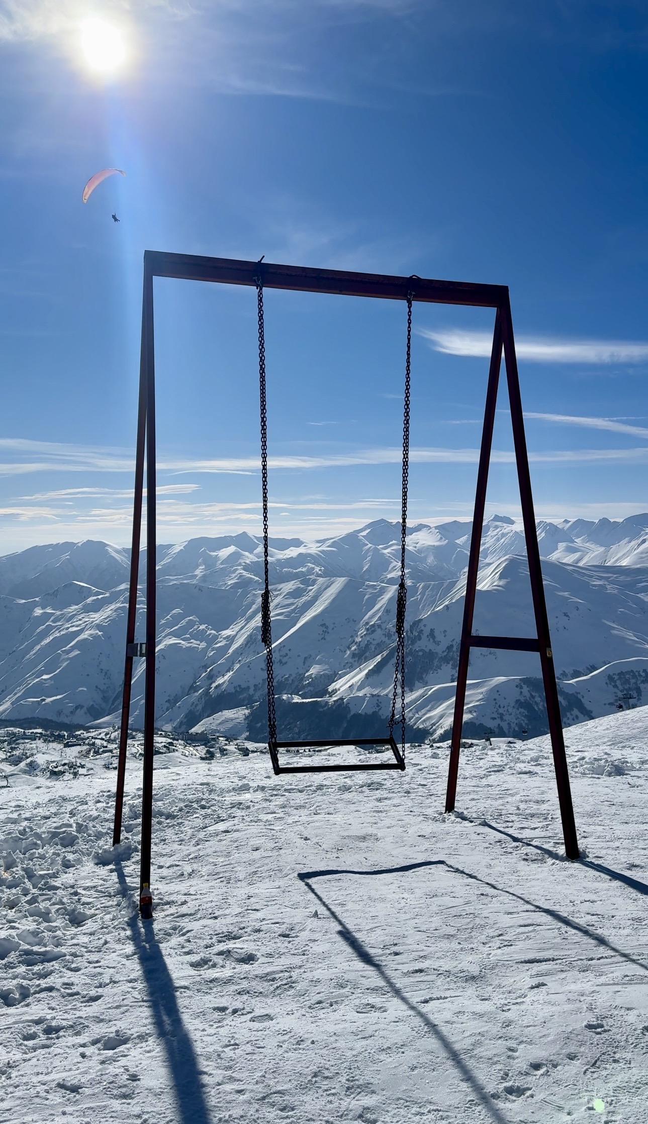 A swing on a mountain in the snow