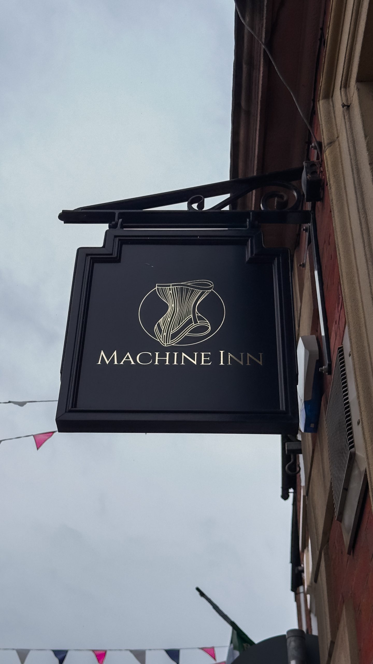 A sign of The Machine Inn outside the pub in Ashbourne