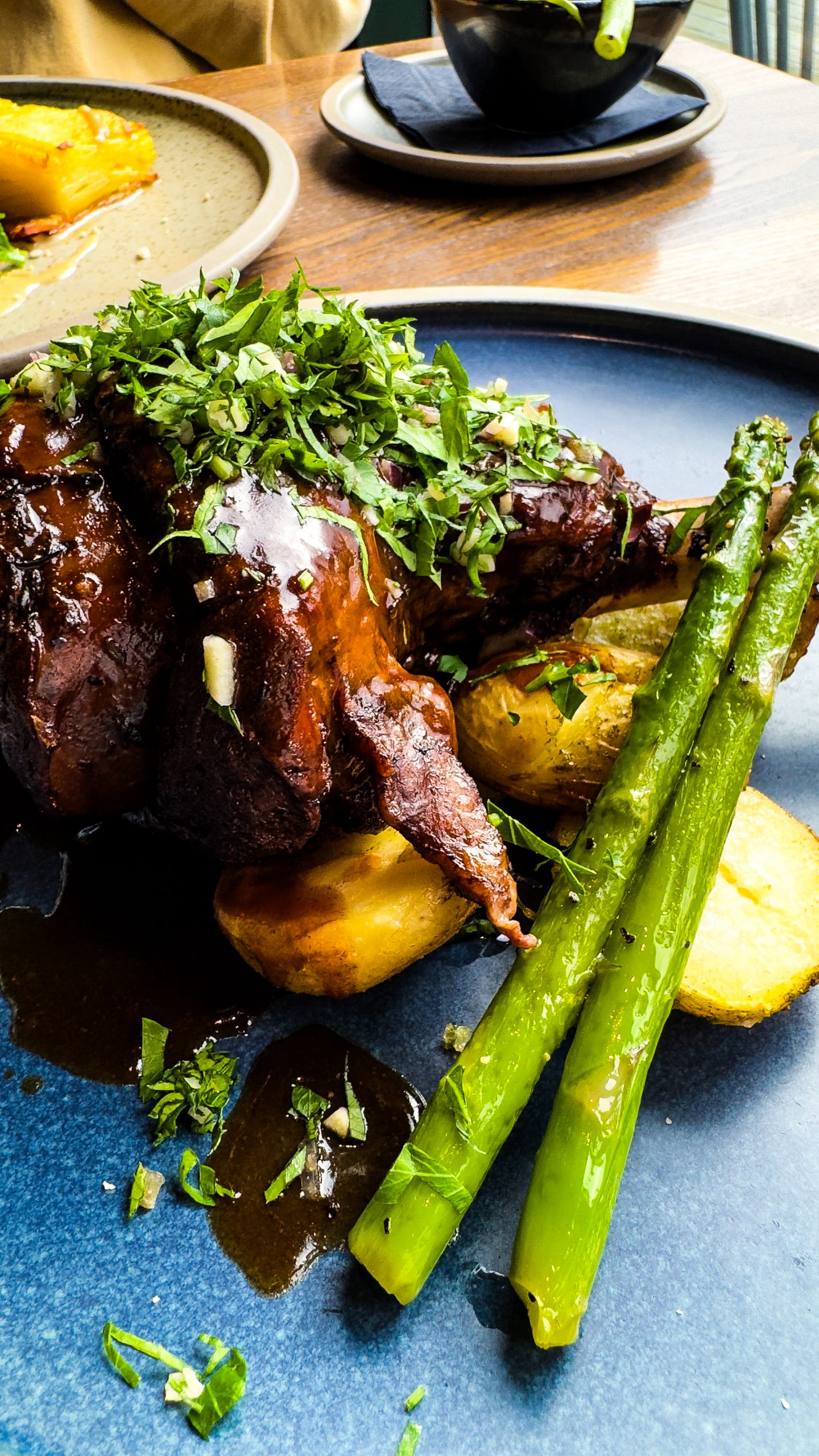 Lamb Shank with Asparagus on a plate at the Maynard Inn during a Peak District walking and wellness break.