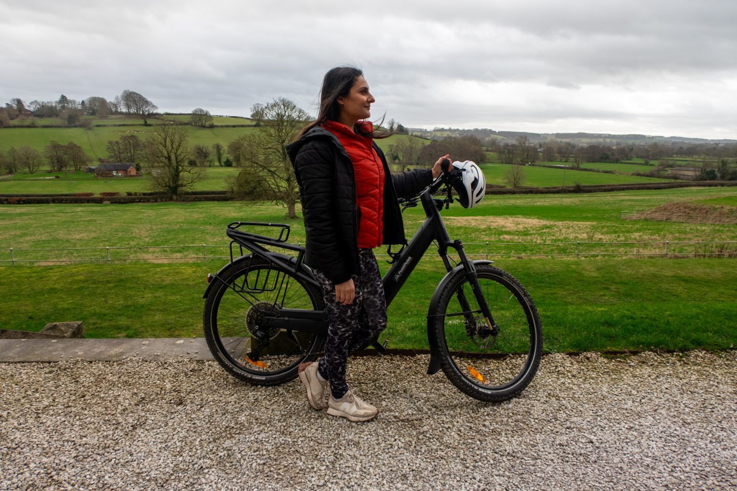A woman standing by an ebike with Peake Pedals ready for a tour of the Tissington Trail in the White Peak