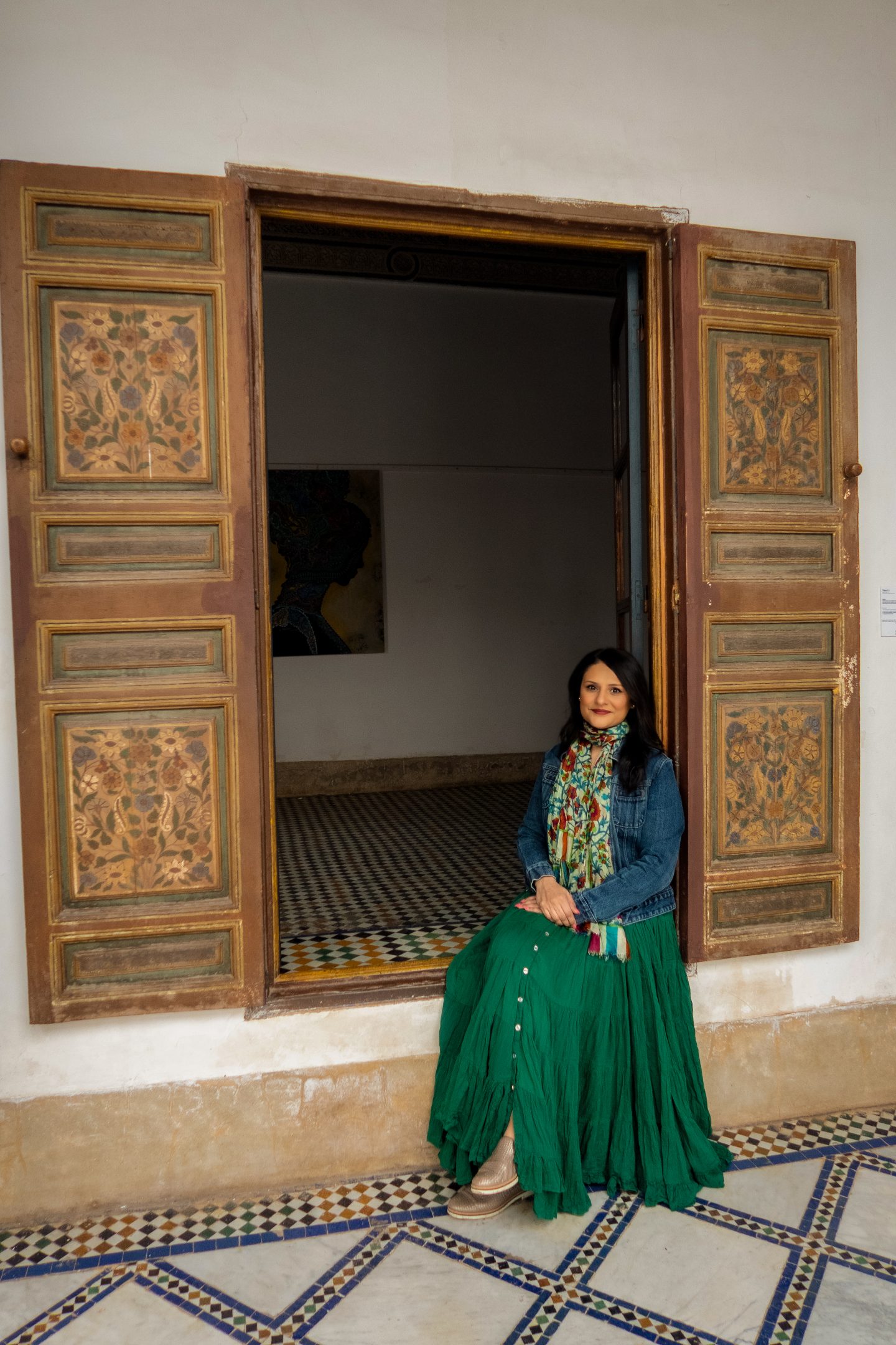 Woman sitting in a doorway at Bahia Palace