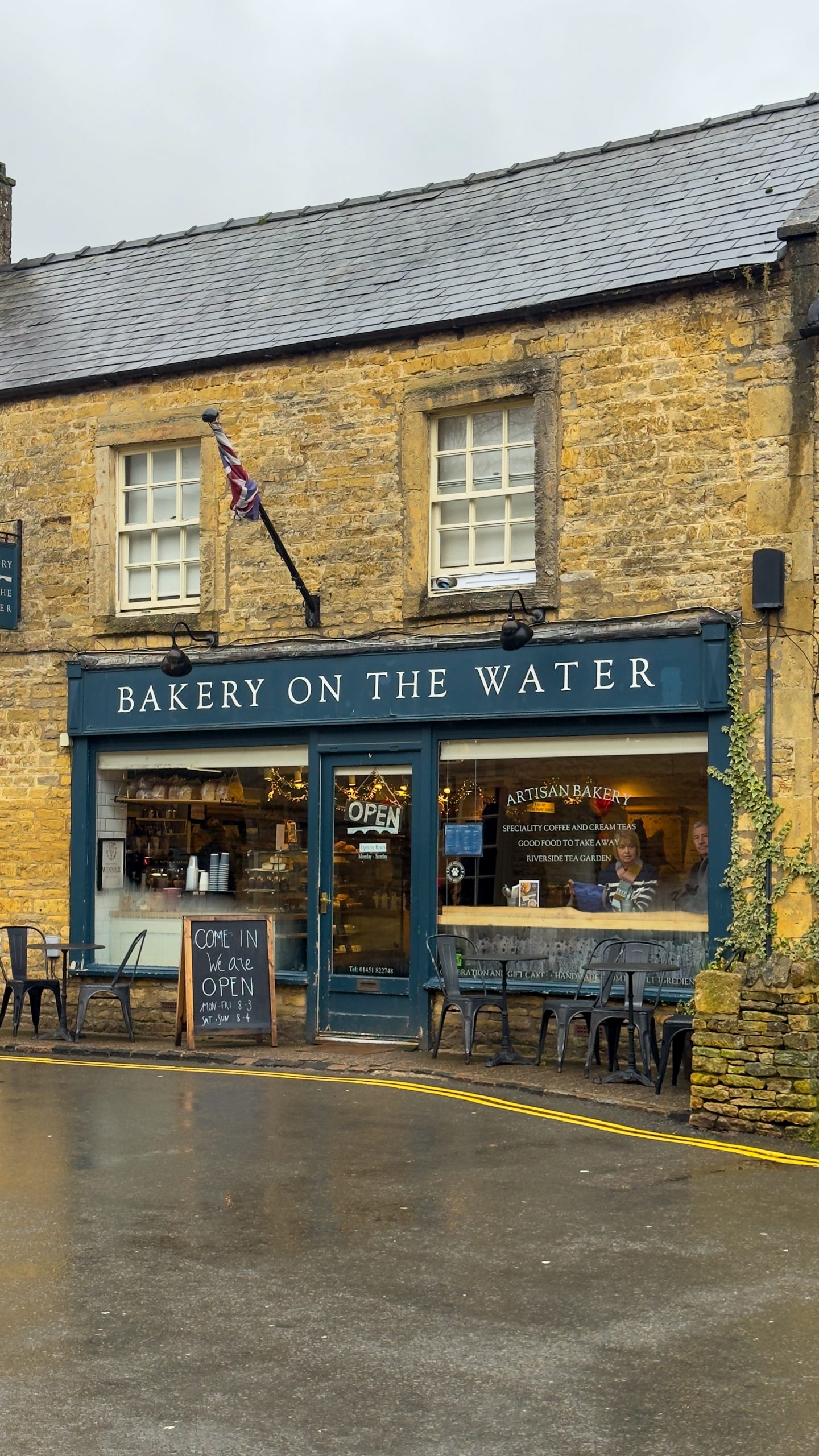 Bakery On the water shop exterior in Bourton On The Water - Cotswolds in the rain