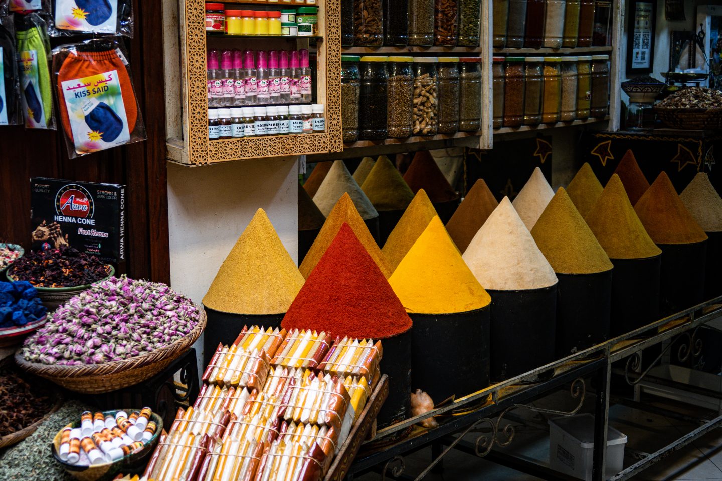 Various colourful spice displays in a market stall