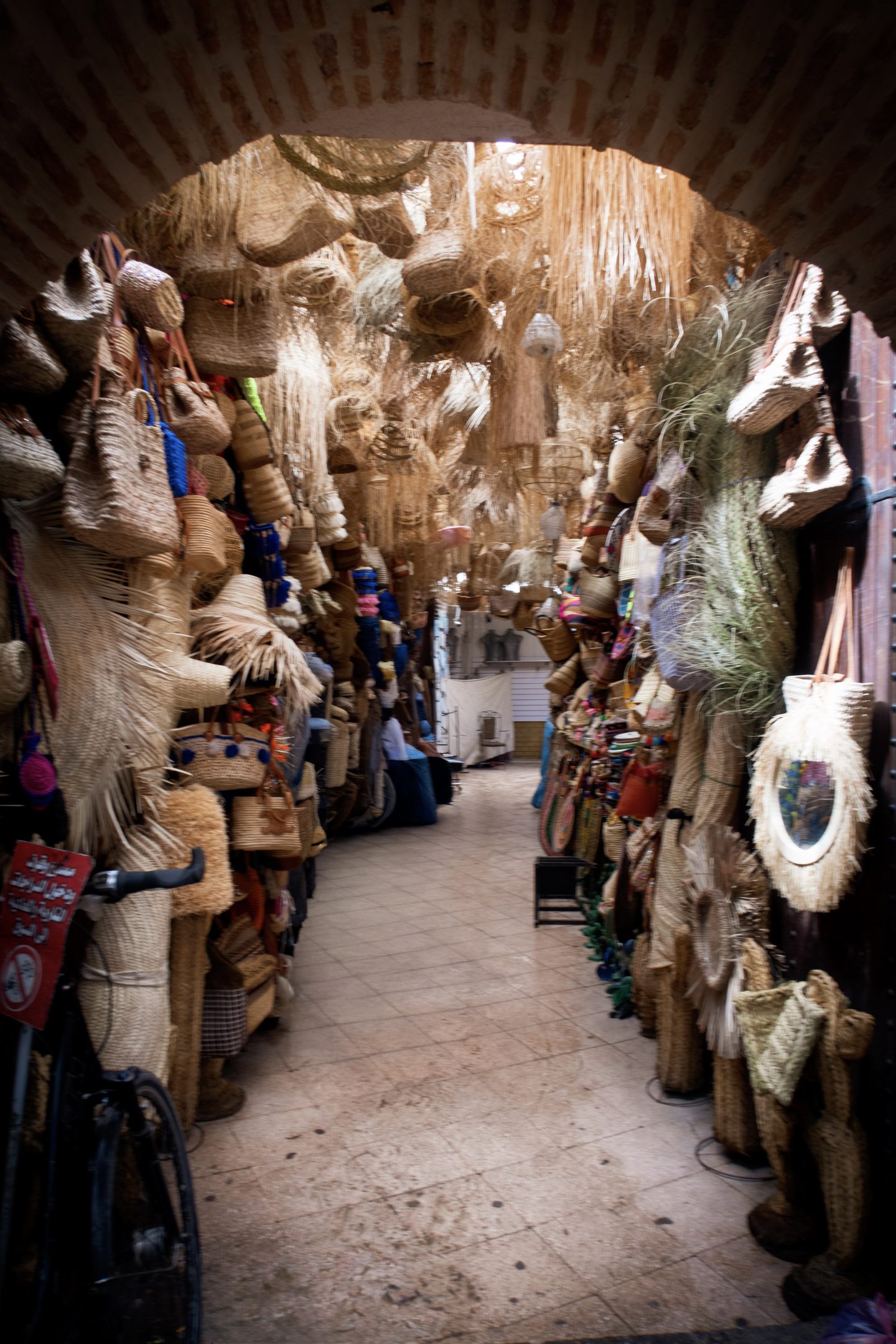 Alleyway with various hats and bags in the souk