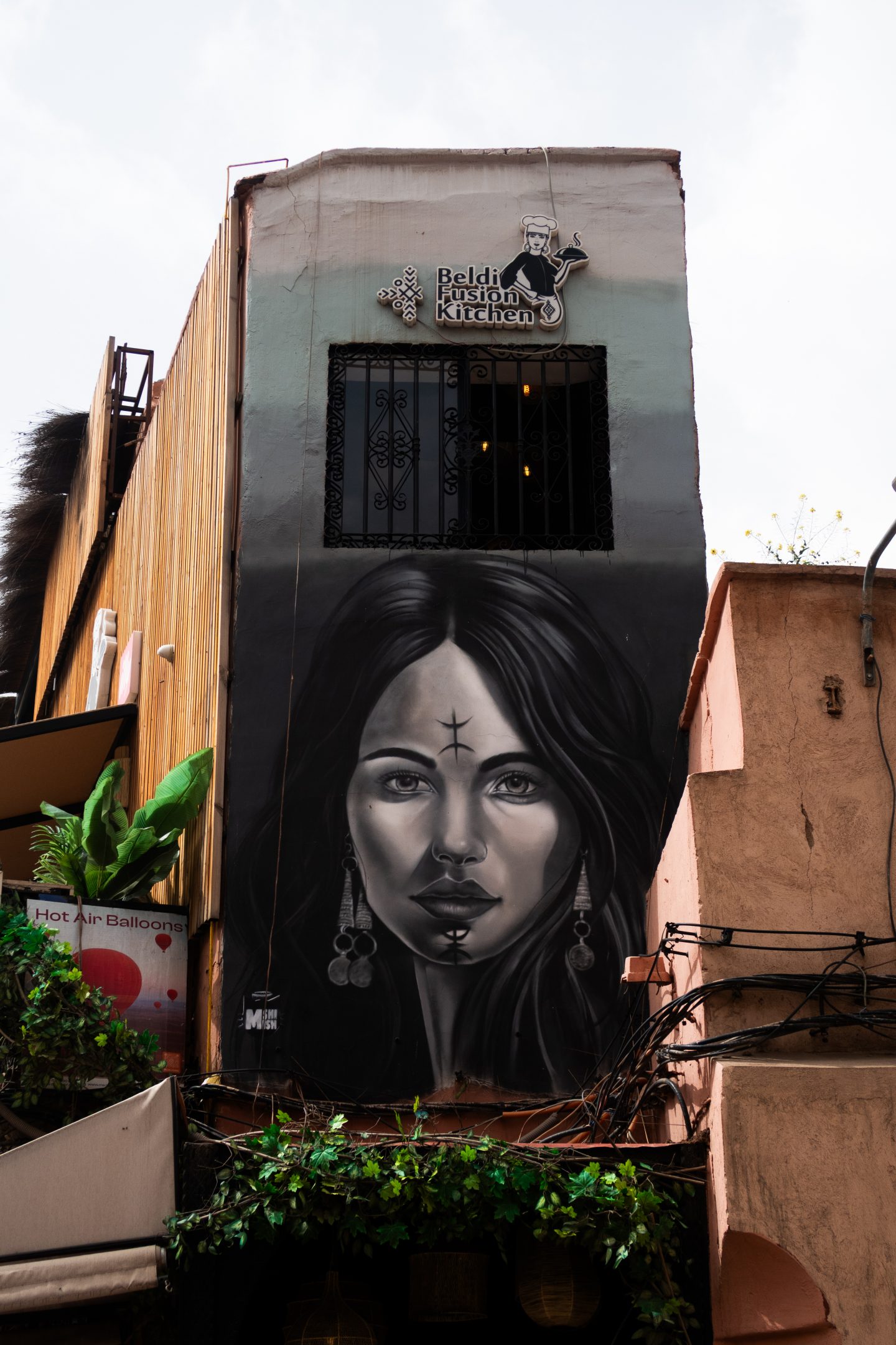 Black and white mural of a woman on the side of a building