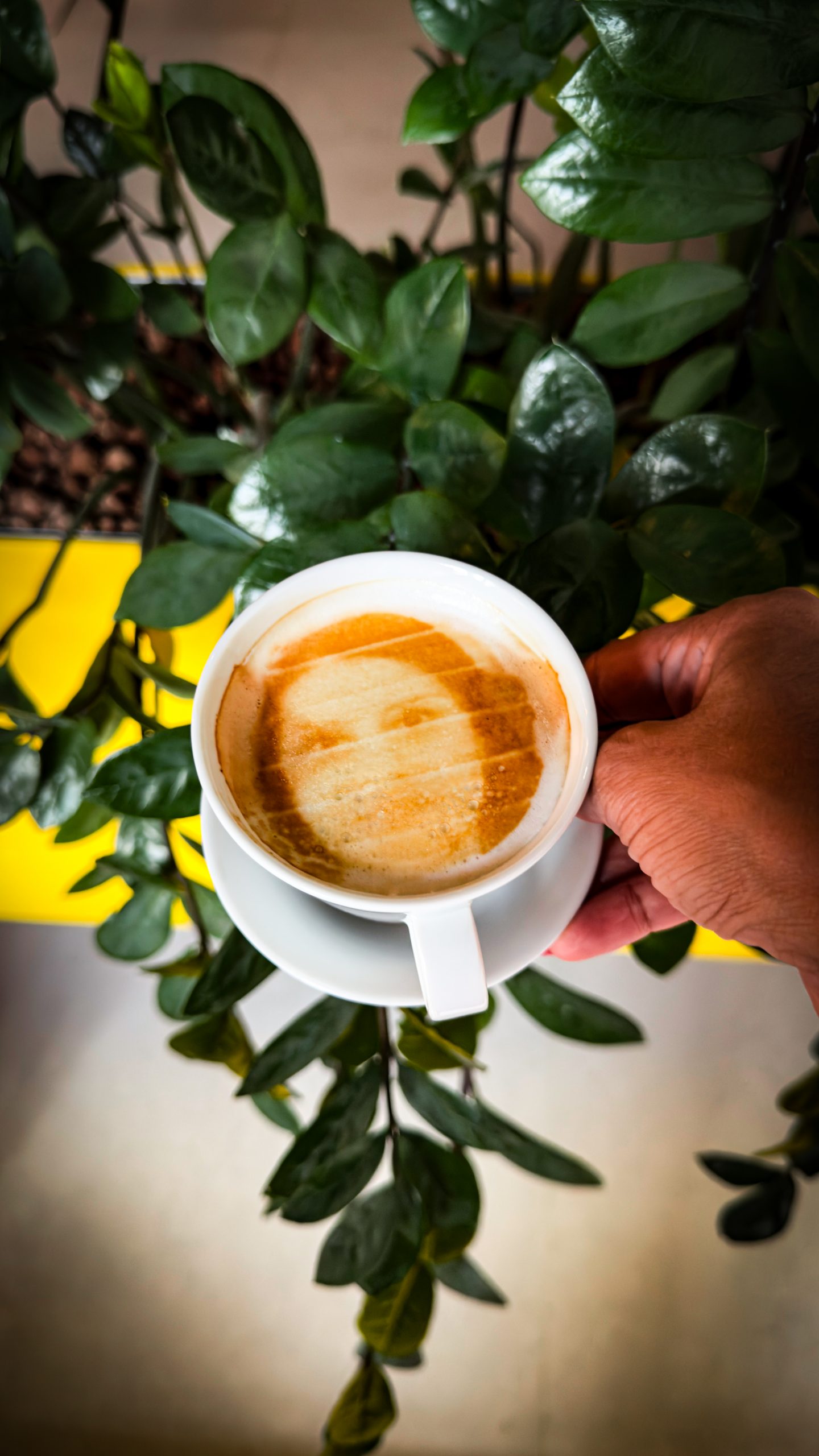 A woman's selfie in the cappucino at Cafe Robot, one of the top things to do in Brno