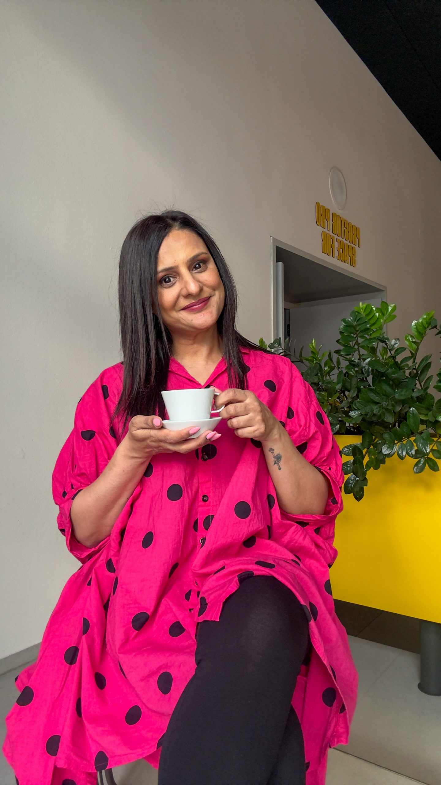 A woman drinking coffee at Cafe Robot