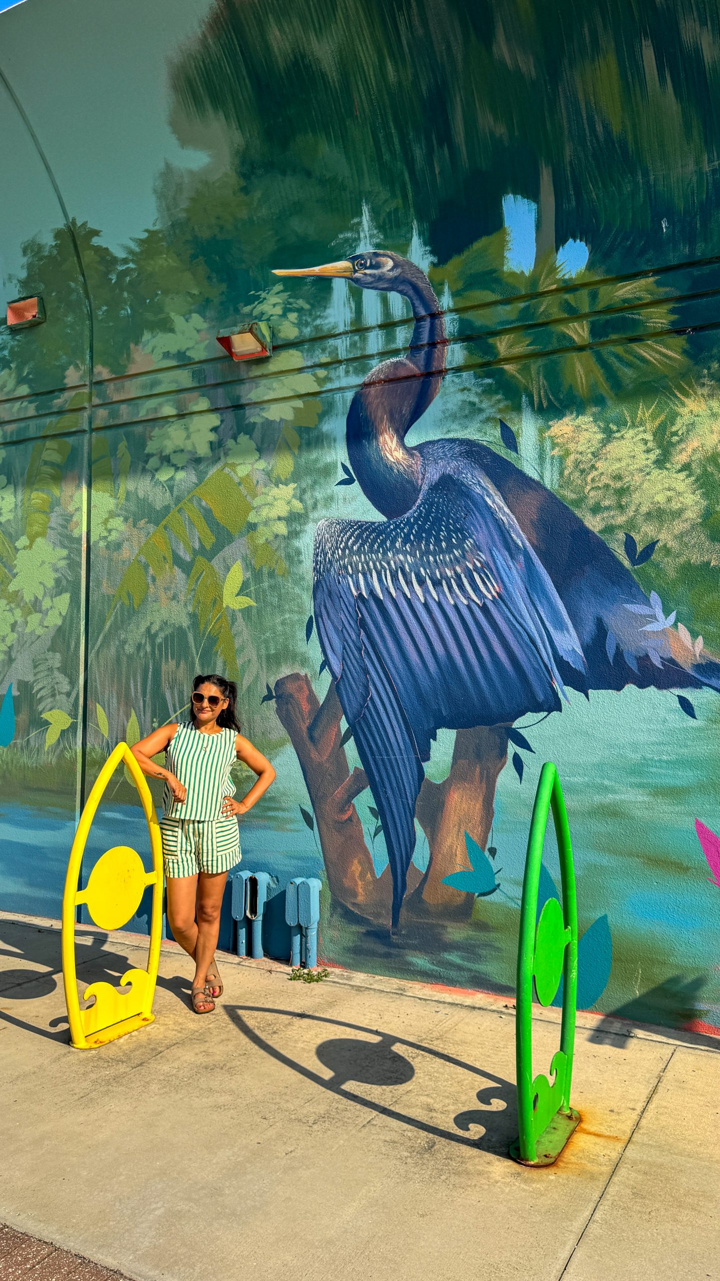 Woman standing in front of a mural on the Mural Art Trail on Jax Beach