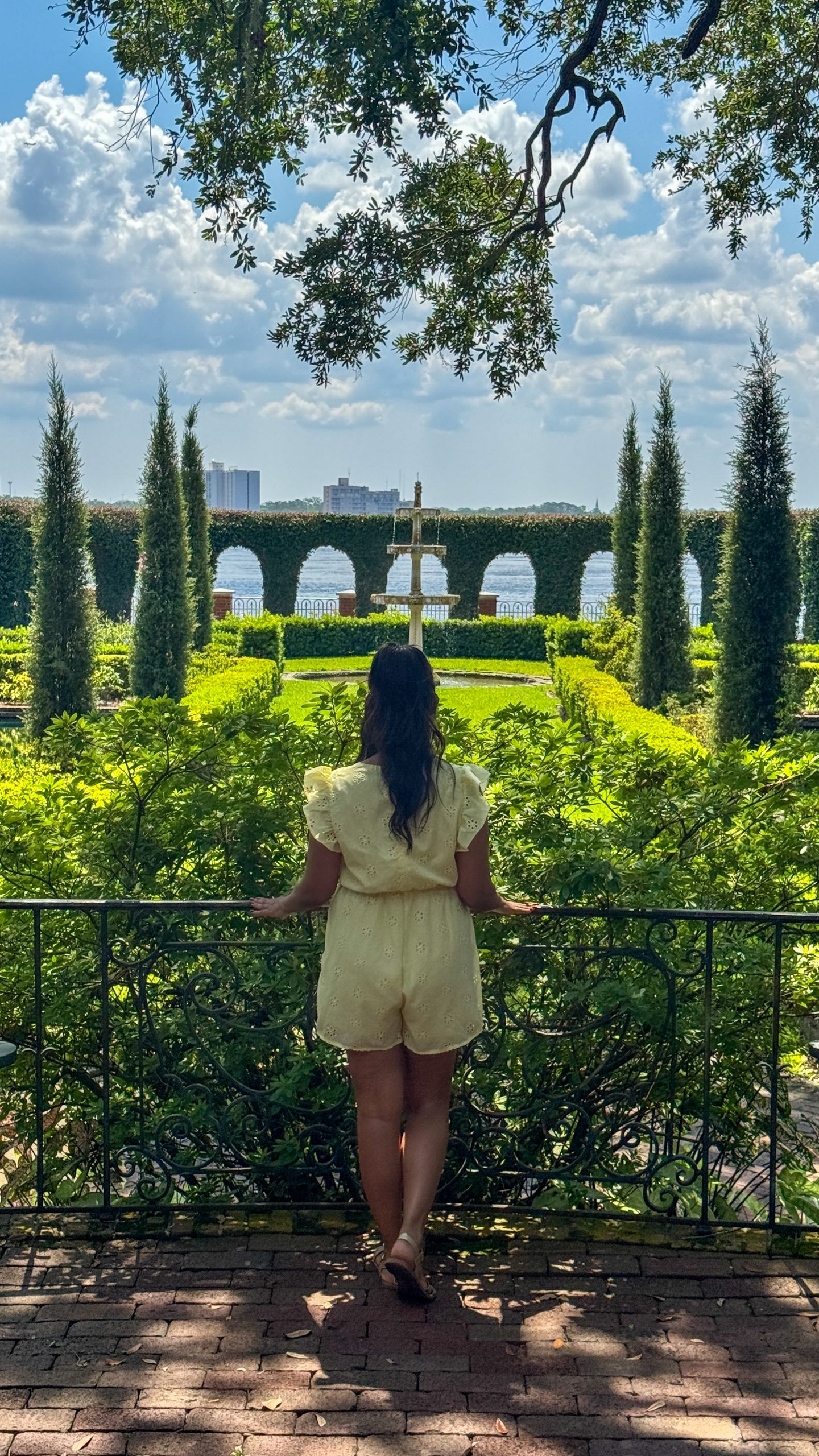 Woman standing in the gardens at Cummer Museum of Art and Gardens in Jax